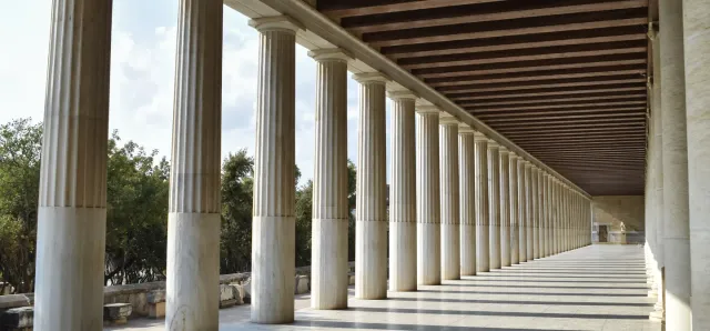 The long marble colonnade of the reconstructed Stoa of Attalos in Athens, its columns receding under a wooden roof